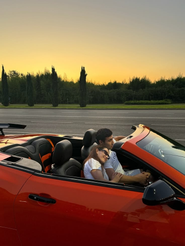 Couple on a sunset drive in a convertible